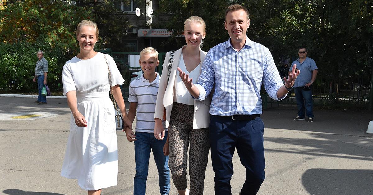 Alexei Navalny walking outside with his family. 