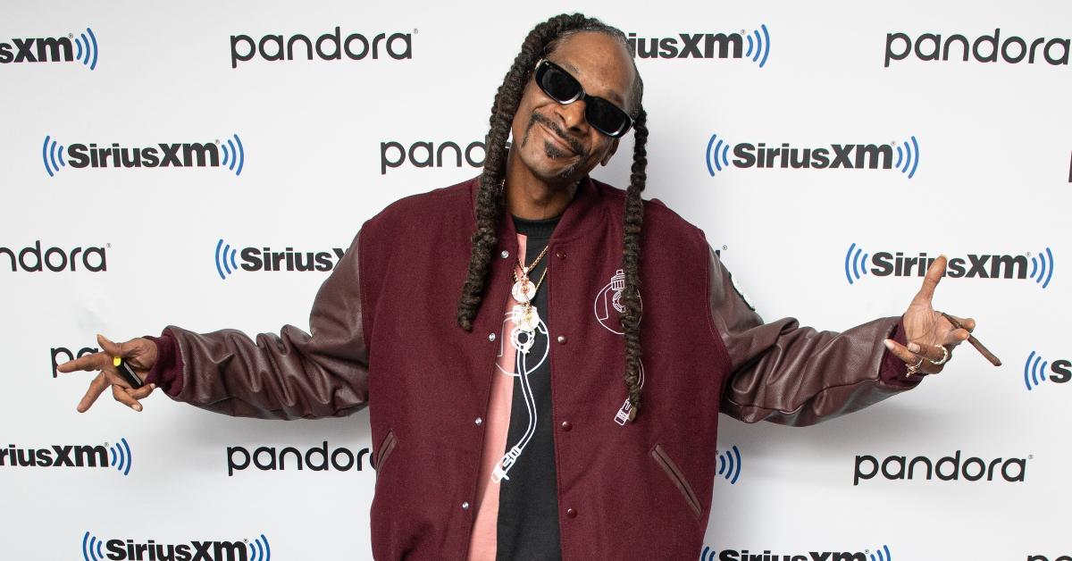 Snoop Dogg wears a lettermans jacket and sunglasses at Sirius XM's Rock the Bells concert.
