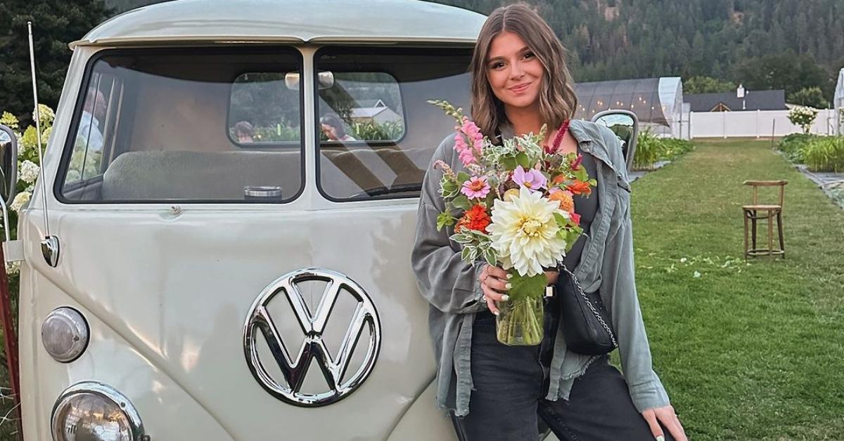 Rachel Leaviss stands in front of a VW bus