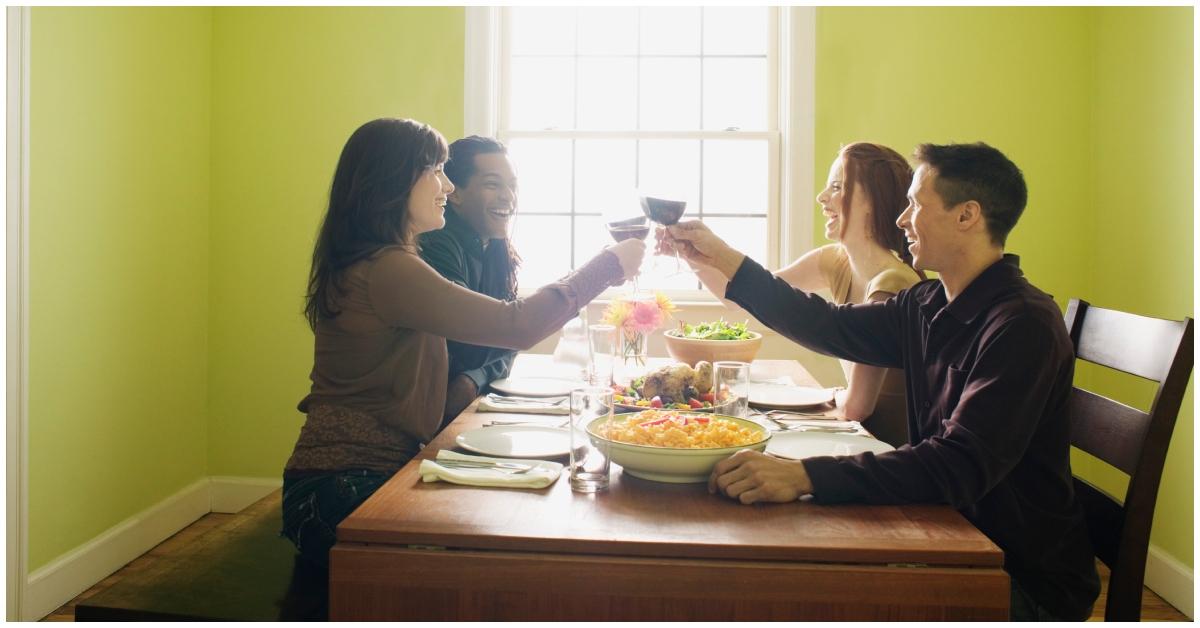 Friends toasting at a dinner table