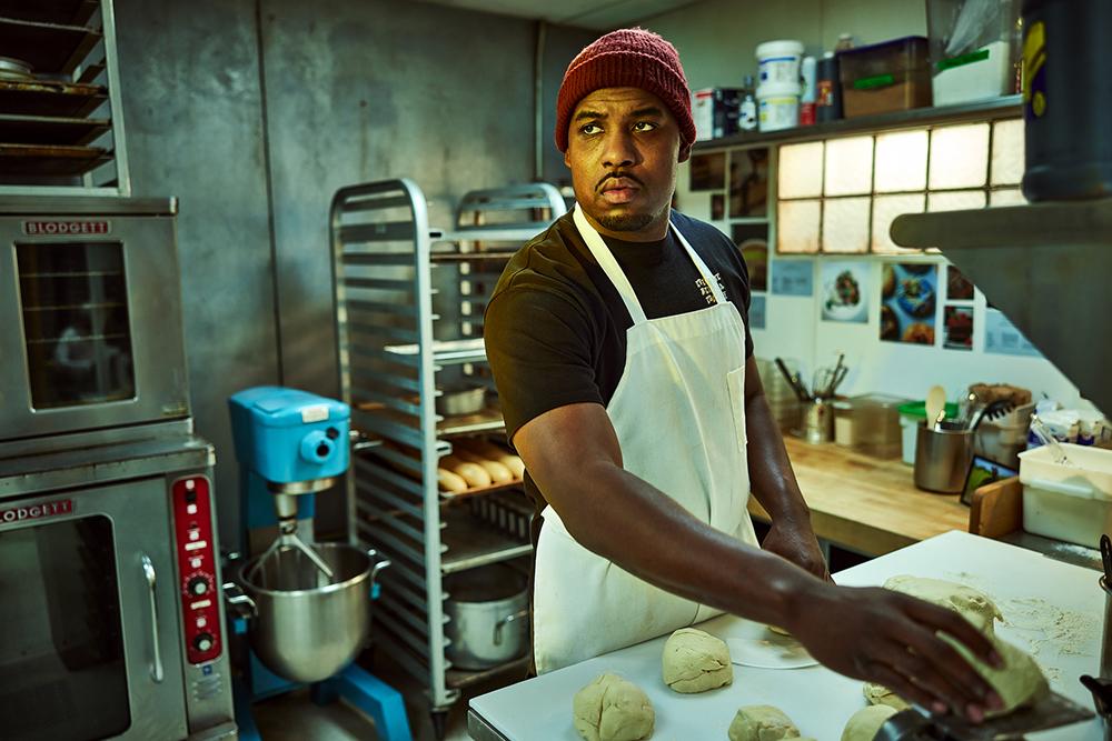 Lionel Boyce as Marcus in 'The Bear' looks tense while baking bread.