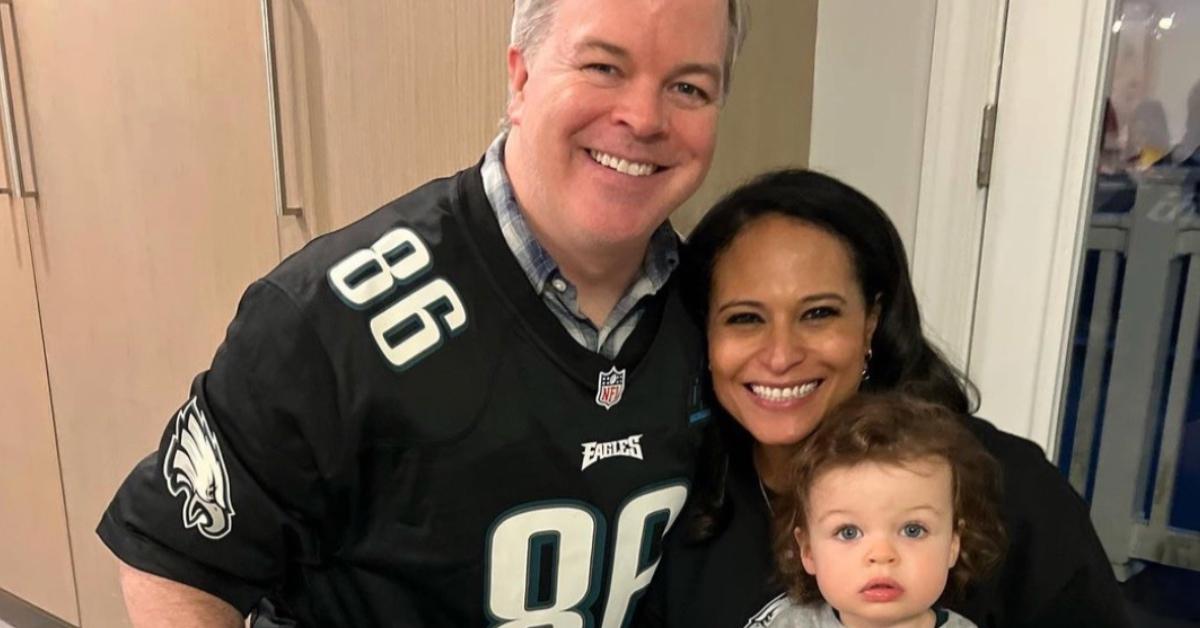 Kristen Welker with her husband and their daughter at a party.