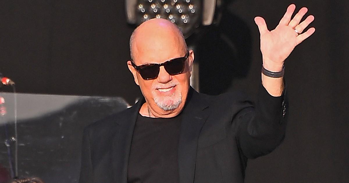 Billy Joel waving during a concert