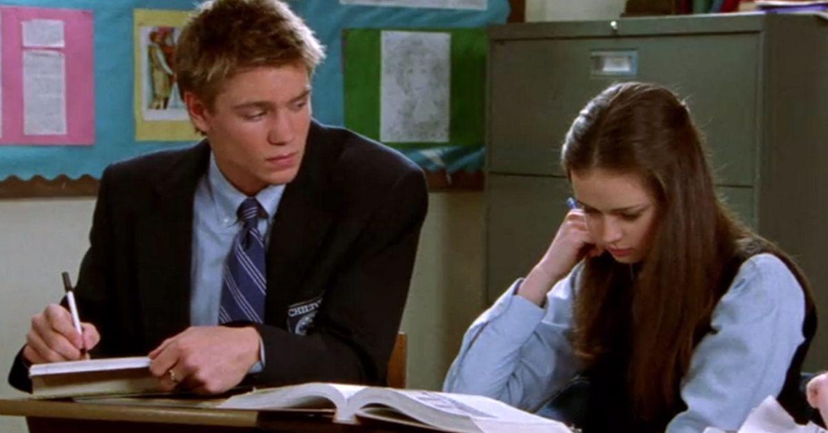 Tristan stares at Rory as she reads a textbook in class at Chilton