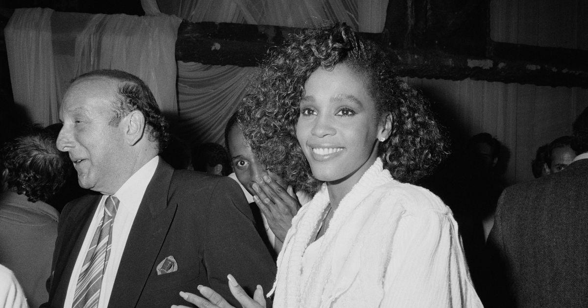 (l-r): Clive Davis and Whitney Houston attending an event in 1985.