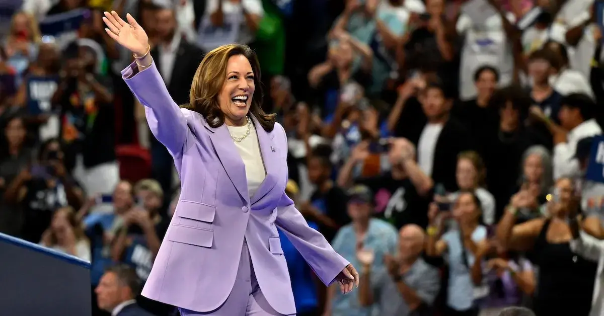 Kamala Harris in a purple suit at a rally