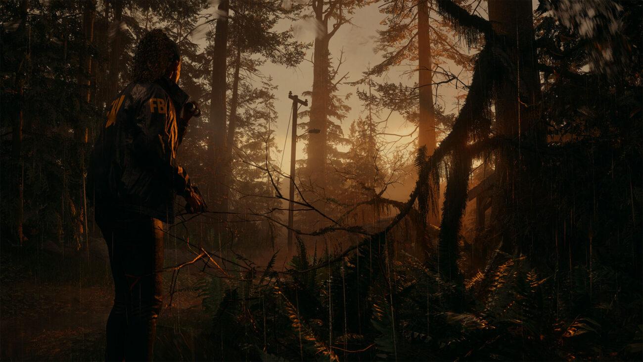 'Alan Wake 2' Saga Anderson standing in a rainy forest at sunset.