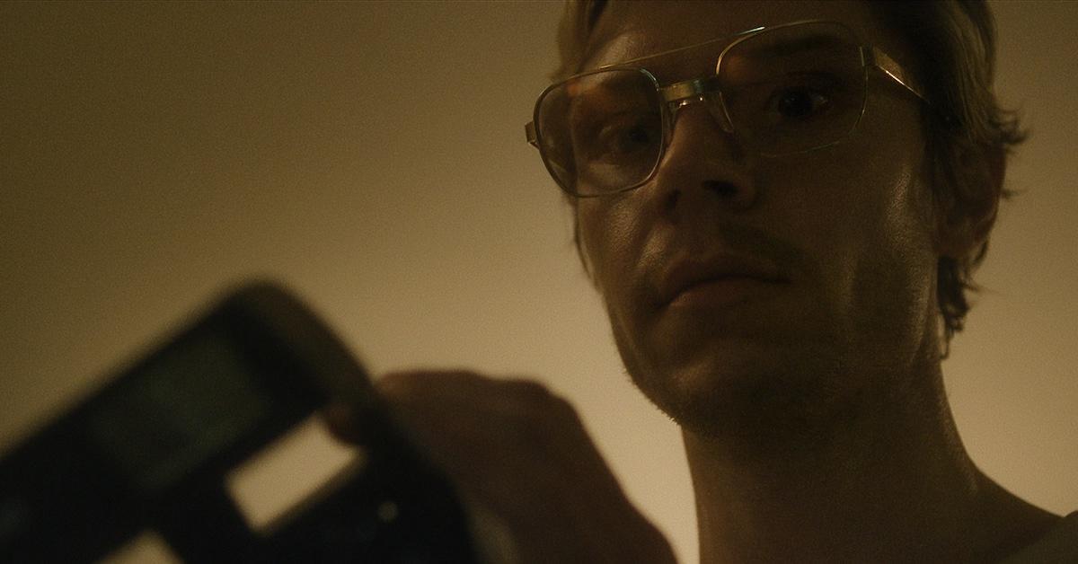 Evan Peters as Jeffrey Dahmer with camera in 'DAHMER - Monster: The Jeffrey Dahmer Story'