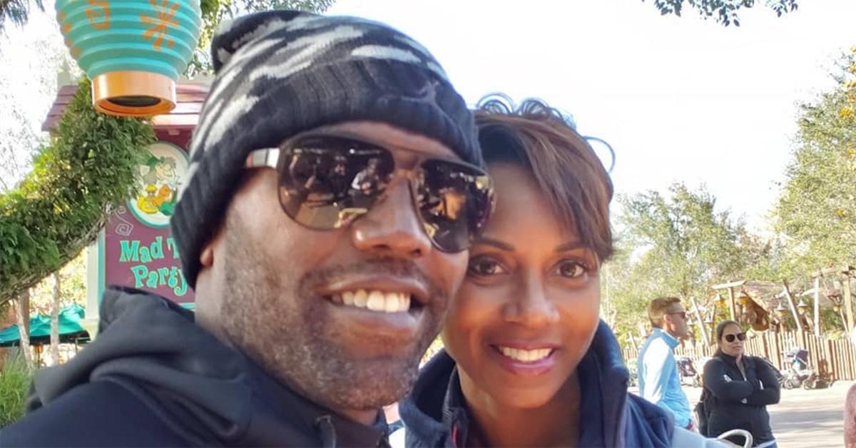 Randy Moss in a hat with his child at Disney World. 