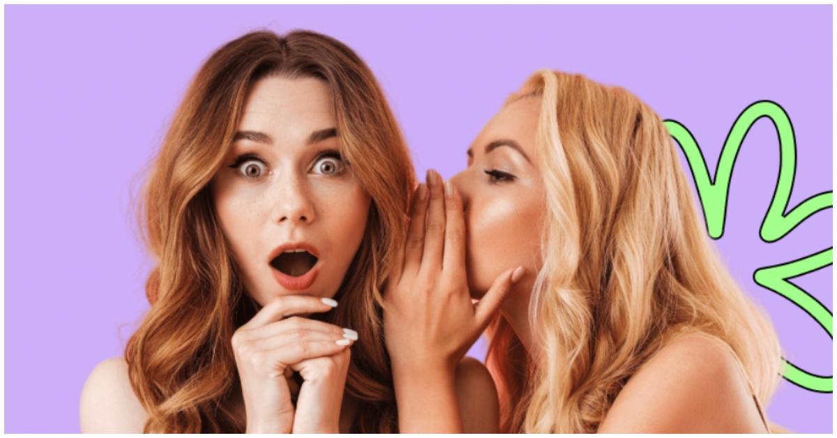 A woman whispering in another woman's ear