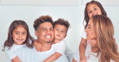 the ace family all wearing white shirts and gray sweatpants