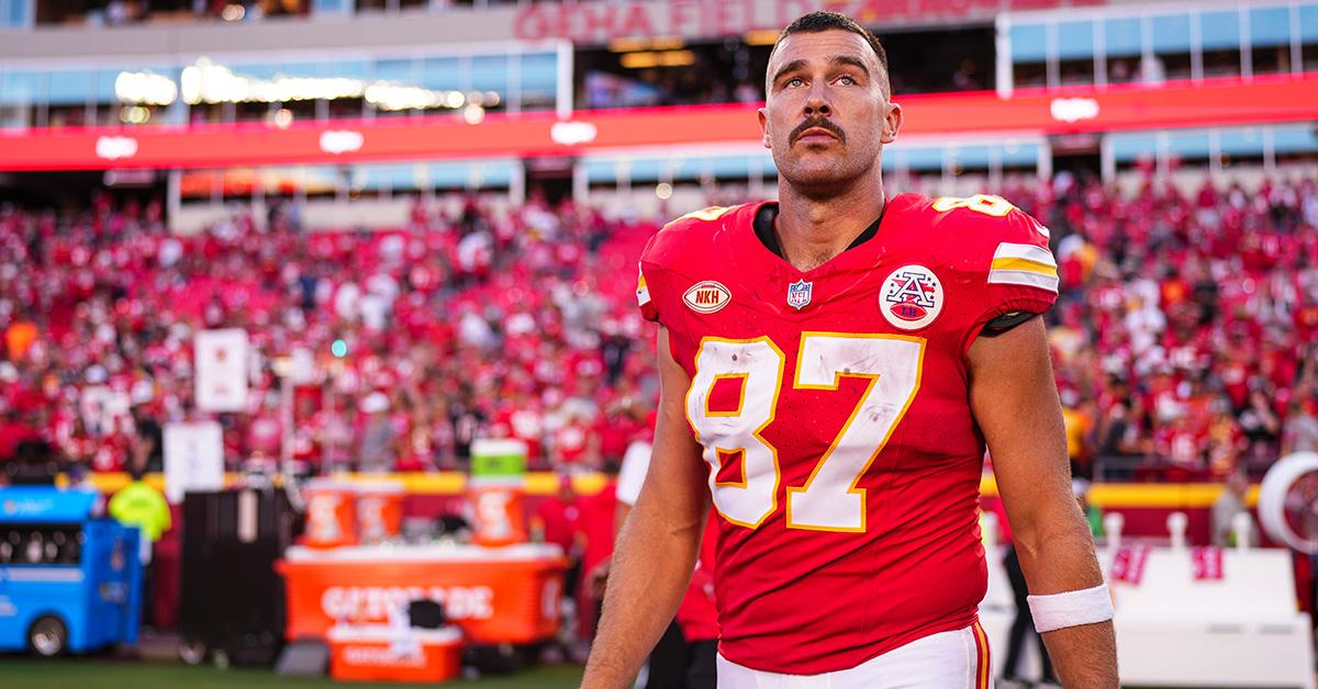 Travis Kelce with a mustache at a Chiefs game. 