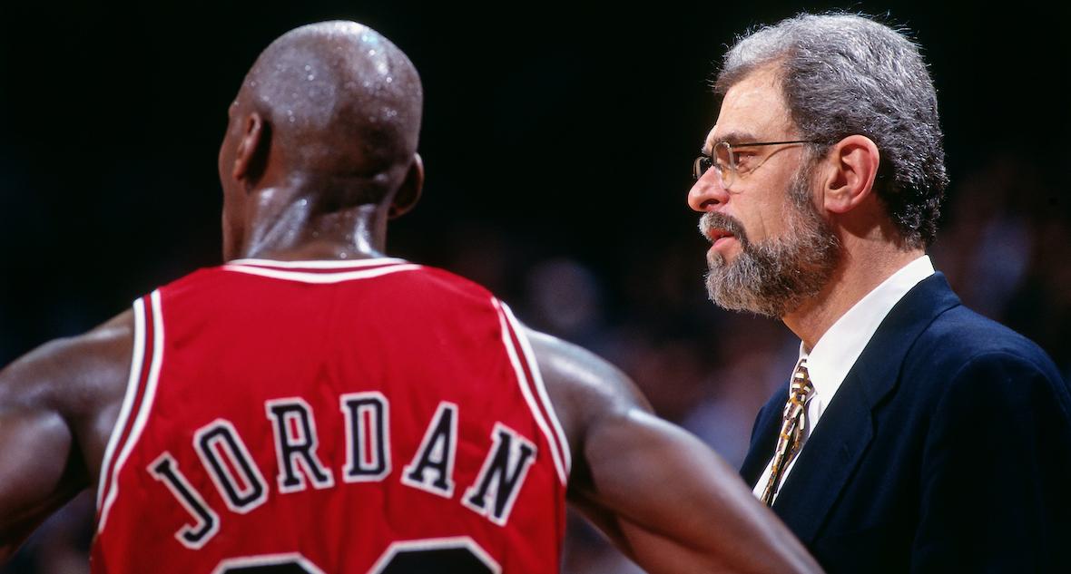 Jud Buechler and Michael Jordan of the Chicago Bulls high five