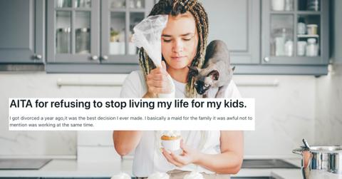 A woman makes cupcakes looks unhappy with cat on shoulder