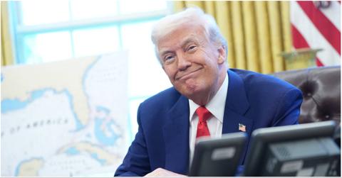 President Donald Trump smirking near a map