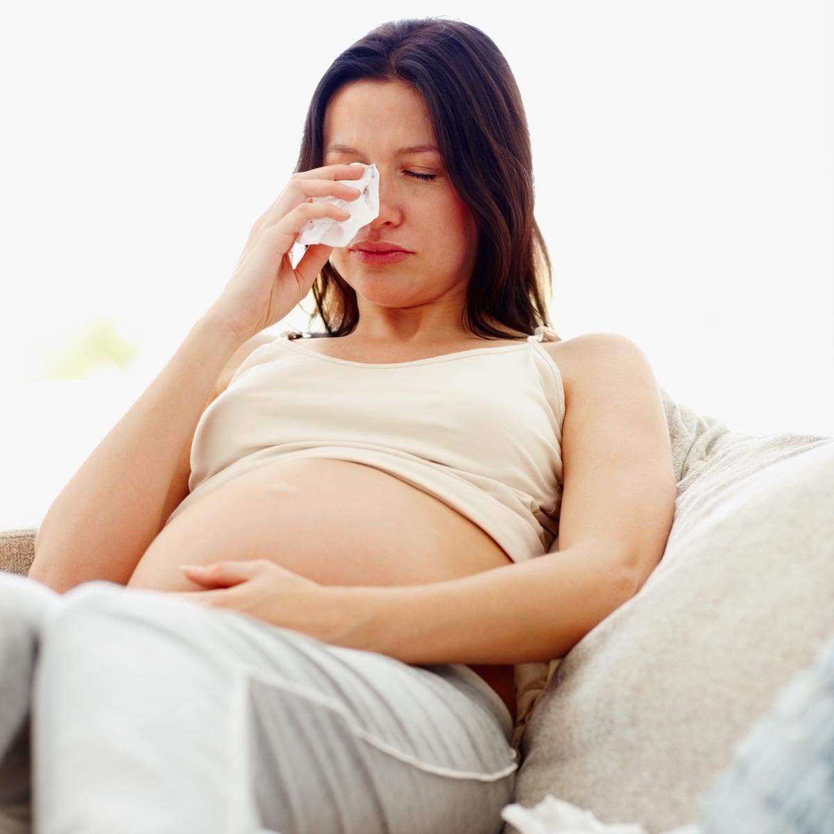 pregnant brunette woman cries.