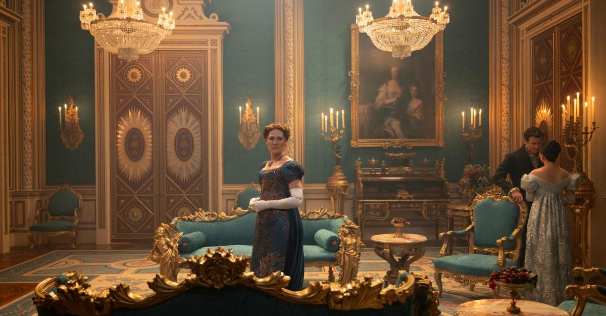 Violet Bridgerton stands in a room with lots of green and gold accents.