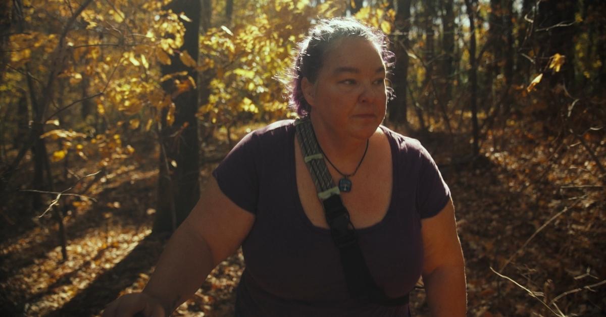 Natasha Teasley, outdoor enthusiast and cyber sleuth, walking in the woods.