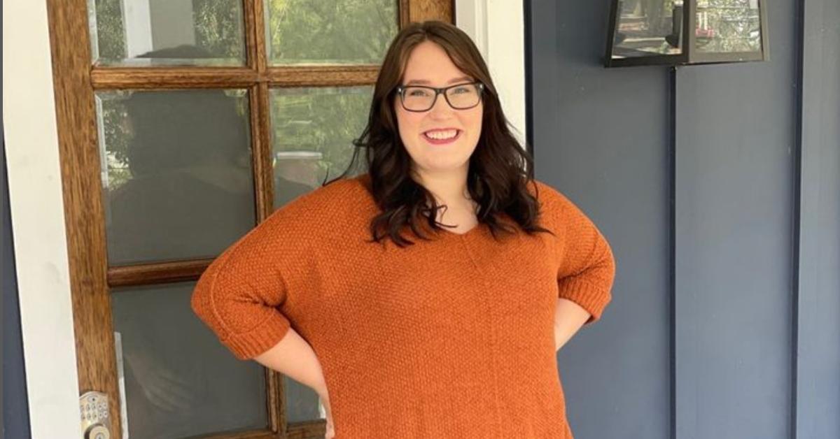 Lauryn "Pumpkin" Efird in orange sweater with dark hair