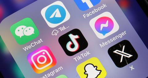 A TikTok logo amid other apps on a phone screen.