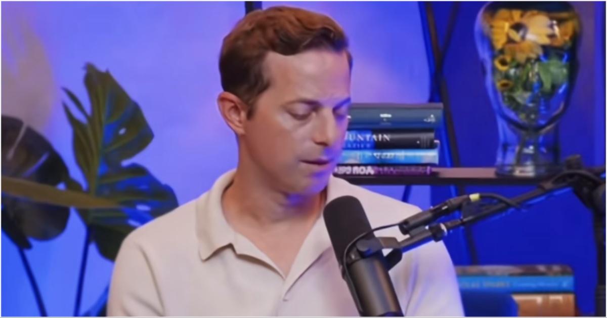 Ned Fulmer looking down while talking on podcast