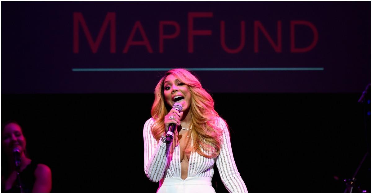 Tamar Braxton singing onstage at an event.