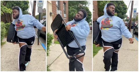 Man walks down the street to Destiny's Child's "Lose My Breath" holding a folding chair.
