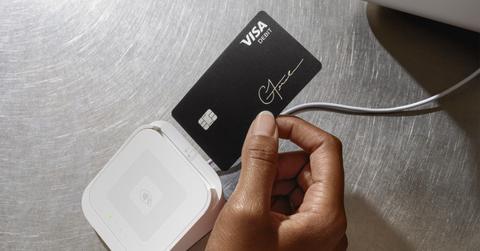 A woman using a Cash App Cash Card