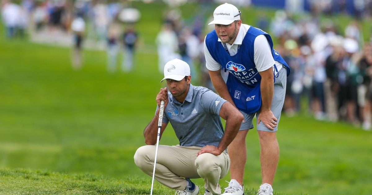 Aaron Rai and his caddie line up a putt at the 2022 Farmers Insurance Open.