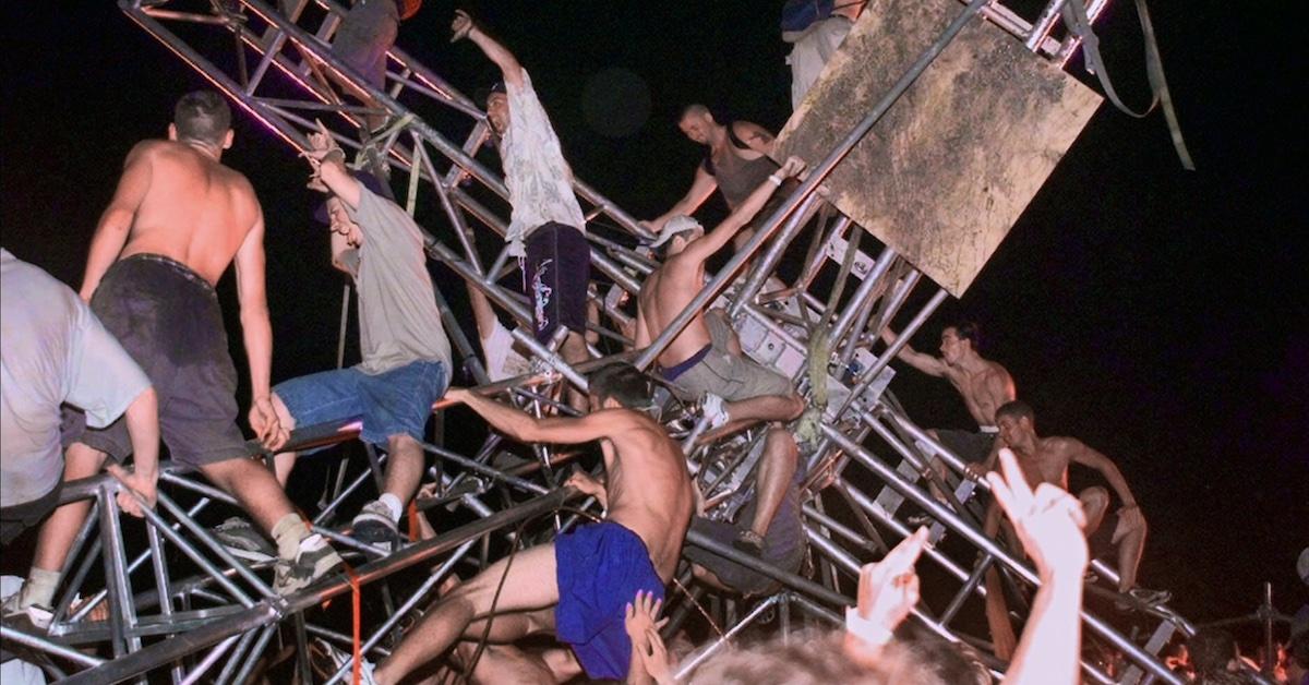 Festivalgoers climb on scaffolding at Woodstock '99