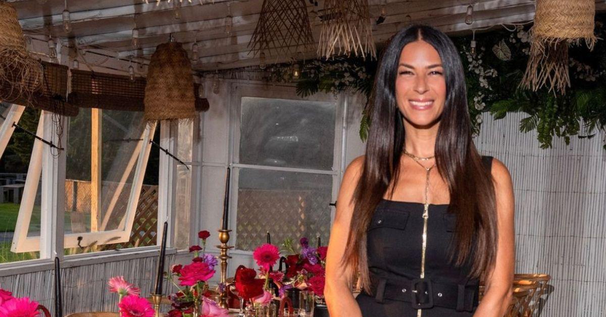 Rebecca Minkoff poses for a photo in front of a decorated table