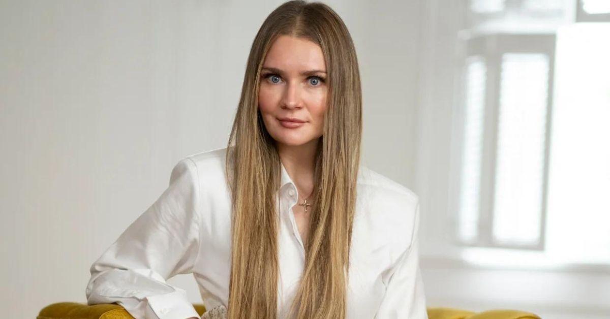 Anna Delvey poses for a photo while seated.