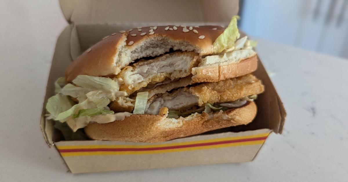 A Chicken Big Mac with a bite taken out of it