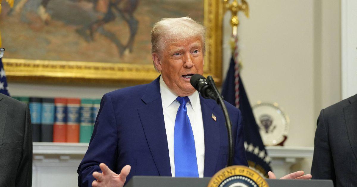 Donald Trump speaking at a presidential podium. 
