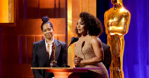 Angela Bassett speaking with Regina King behind her.