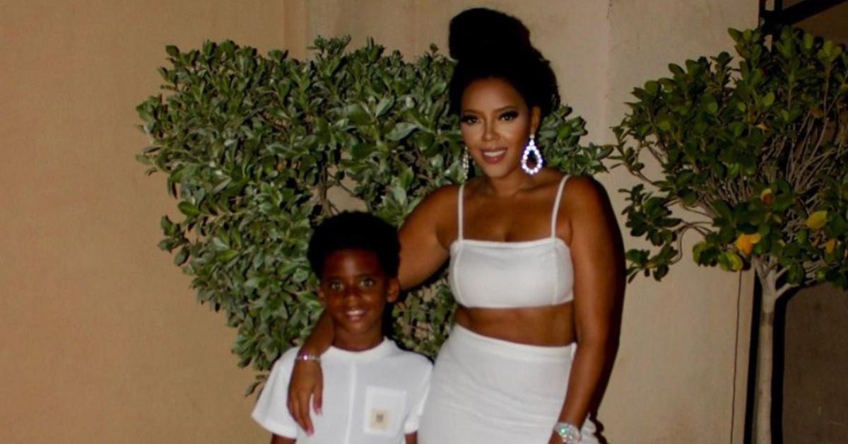 Angela Simmons standing with her son both wearing all white.