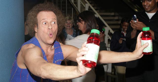 Richard Simmons holding cranberry juice in New York City.