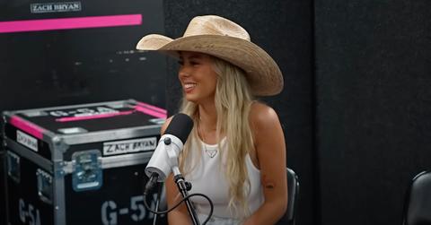 Hawk Tuah Girl in white tank top and cowboy hat during her Plan Bri interview