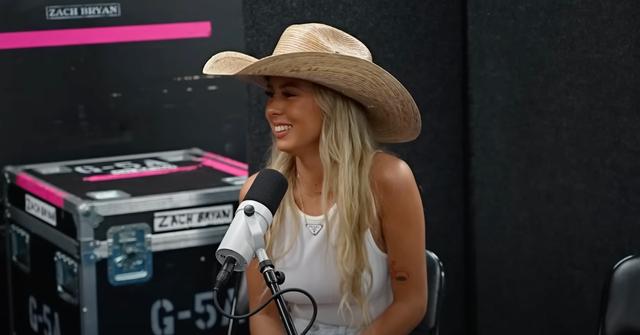 Hawk Tuah Girl in white tank top and cowboy hat during her Plan Bri interview