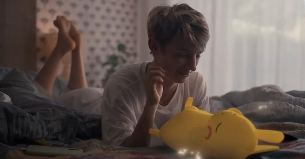A person looking at a napping Pikachu.