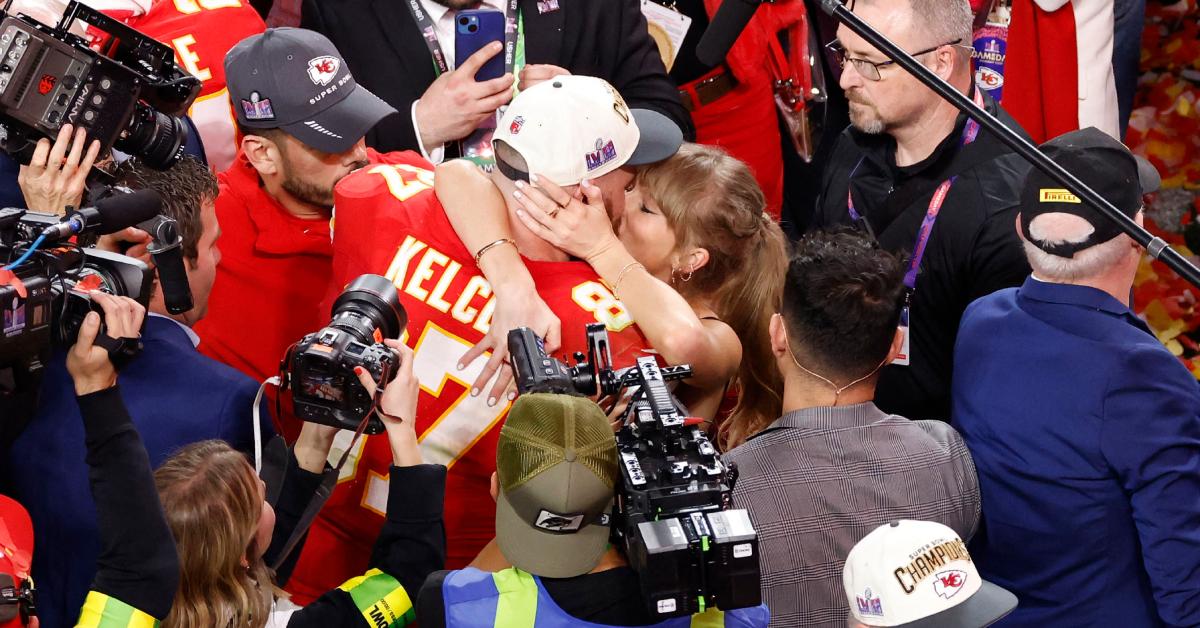 Travis Kelce and Taylor Swift kiss on the field after the Chiefs won Super Bowl LVIII.