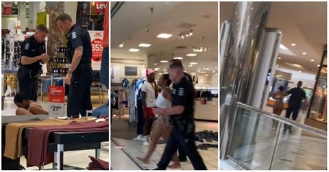 A woman being caught shoplifting in a mall