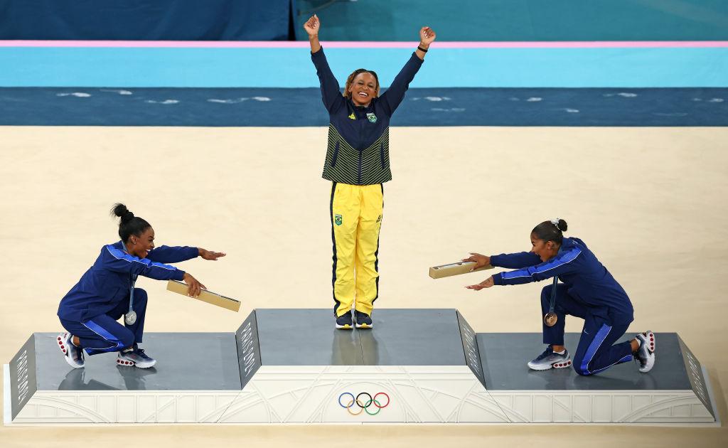 Simone Biles and Jordan Chiles bowing to Rebeca Andrade at the 2024 Paris Olympics