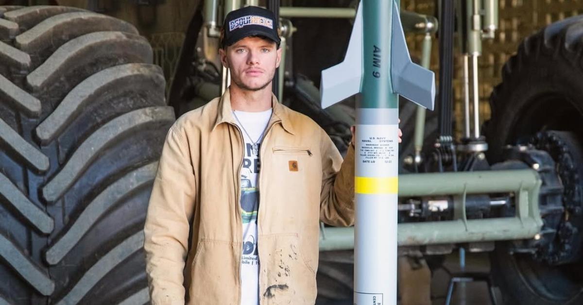 Cody Detwiler with fuel tanks next to his truck.