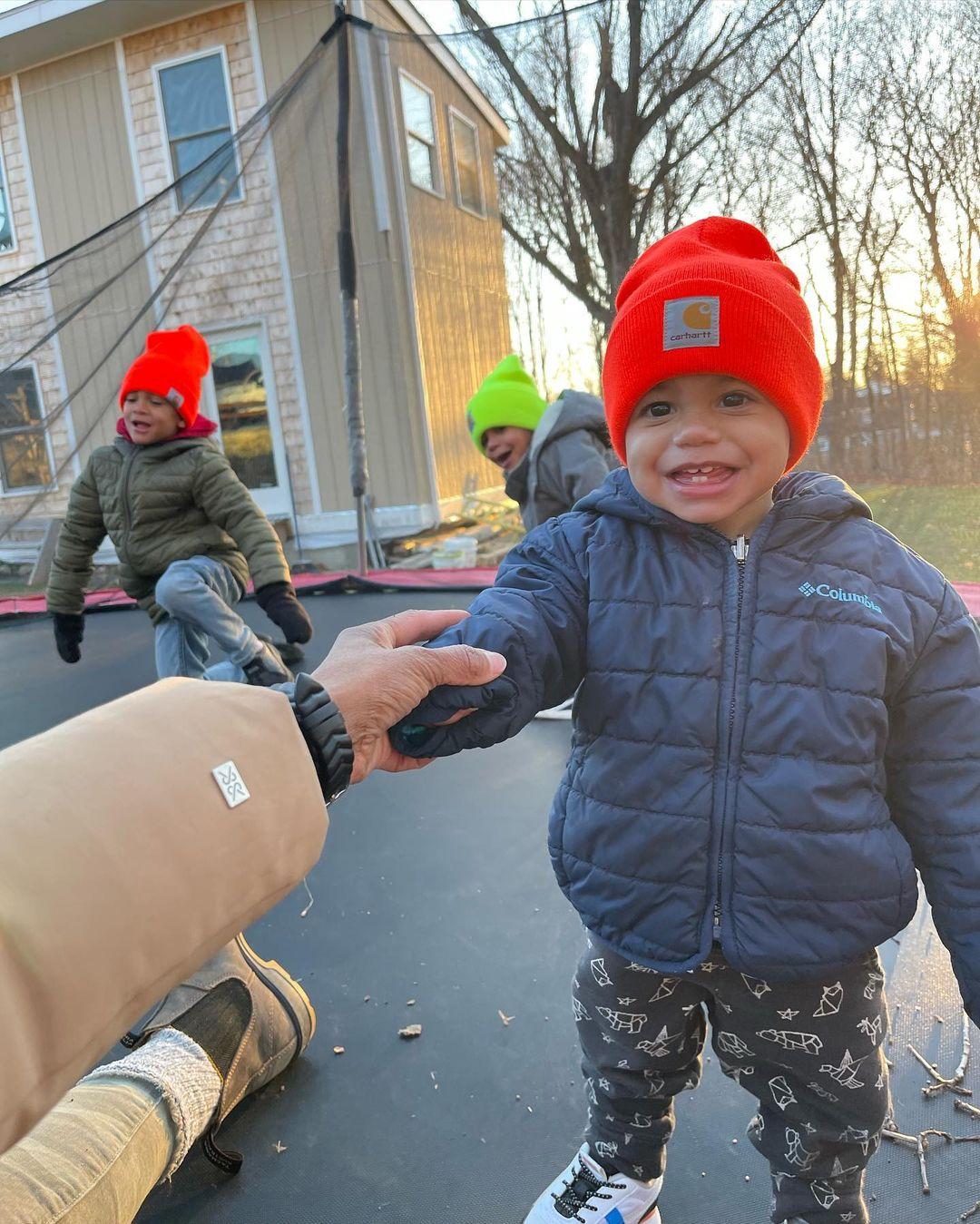 Denese Butler takes a photo of her three sons bundled up and playing outside.