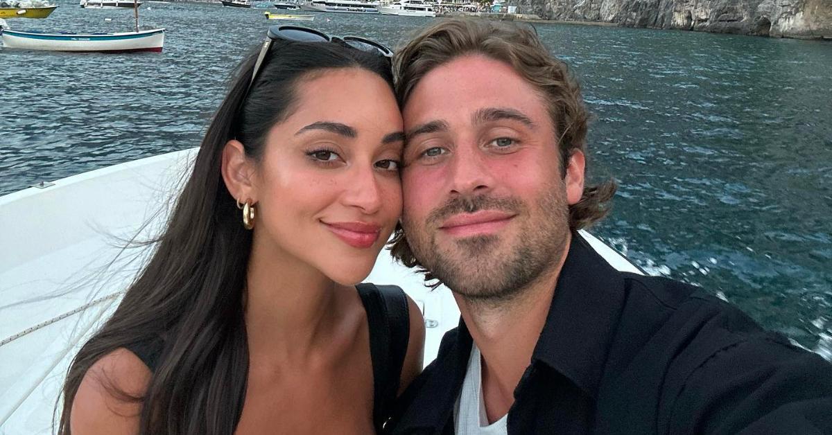 Victoria Fuller and Greg Grippo smile and pose together while on a boat.