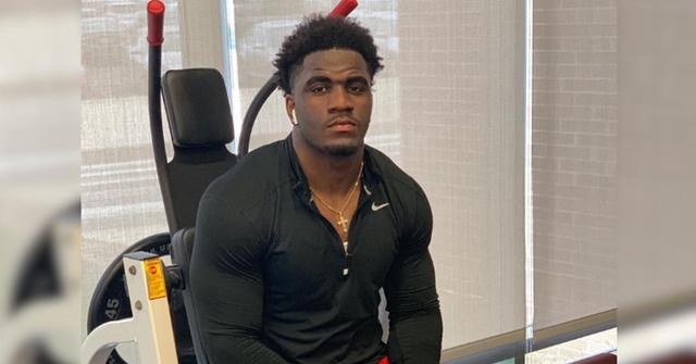 AJ Simon sitting in a gym