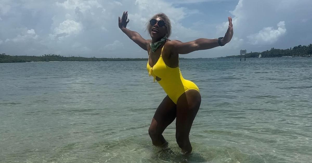 Serena Williams poses in a yellow bathing suit