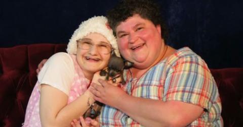 A young Gypsy Rose holding a puppy next to her mother Dee Dee.