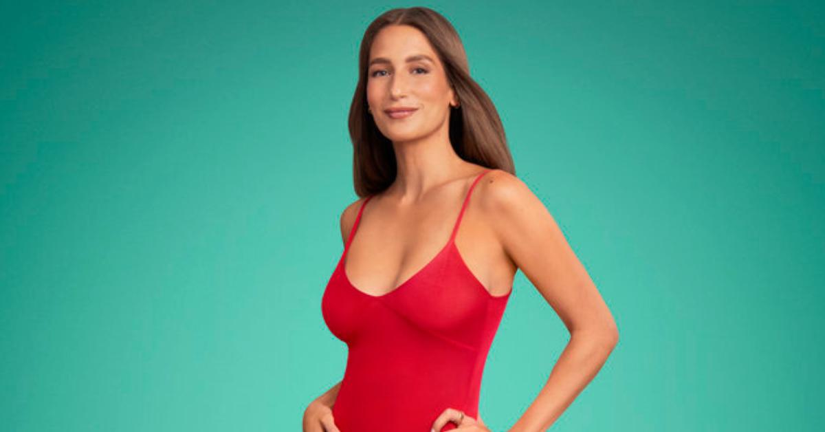 Amanda Batula poses for Season 8 of 'Summer House' in a red spaghetti strap dress.